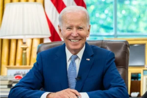 Joe Biden sitting at resolute desk